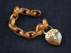A tortoiseshell oval link bracelet with ornate gold mounted heart shaped padlock with key, 8.5in.