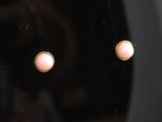 A pair of Italian 18ct gold and cabochon pink opal set ear studs retailed by Garrard.
