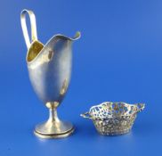 A late 19th/ early 20th century continental silver helmet shaped cream jug, with swag engraved