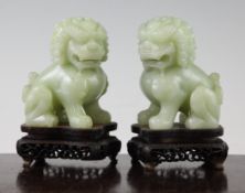 A pair of Chinese pale green bowenite figures of Buddhist lions, 20th century, each in seated