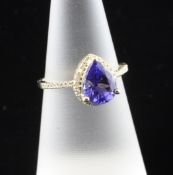 A 14ct gold, diamond and pear shaped tanzanite set dress ring, the central stone with diamond border