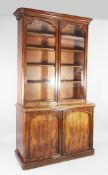 A Victorian mahogany bookcase, the moulded cornice above two glazed doors over two recessed panelled