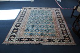 A Turkish Ghiordes style rug, with field of geometric motifs on a pale blue ground, with four row