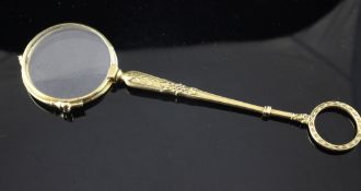 A pair of French 18ct gold lorgnettes, with foliate decorated handle with ring terminal, 6IN.