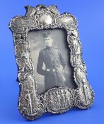 A late Victorian Boer War related silver photograph frame, embossed with soldiers, rifles, canons