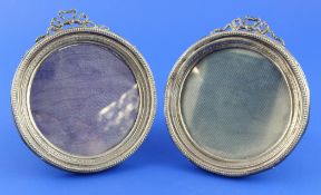 A pair of early 20th century silver photograph frames, of circular form, with beaded borders and