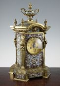 An early 20th century French ormolu and champleve enamel mantel clock, surmounted with an urn,