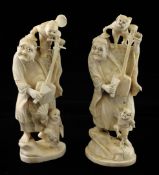 A pair of Japanese walrus ivory groups, early 20th century, each carved as a man playing a