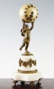 An early 20th century ormolu and white marble mantel timepiece, modelled with a putto supporting a