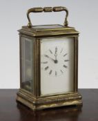 A late 19th century gilt brass carriage clock, gorge case, with enamelled Roman dial and movement