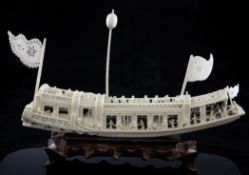 A Chinese ivory model of a boat, first half 20th century, carved with figures aboard, 31.5cm.,