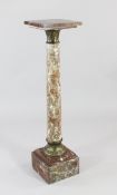 A late Victorian rouge marble pedestal column, with stiff leaf carved terminals and stepped square