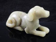 A Chinese green jade figure of a recumbent hound, in Song dynasty style, 10cm.