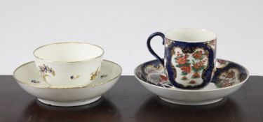 A Worcester blue-scale ground cup and saucer, c.1770, decorated with flowers and foliage in the