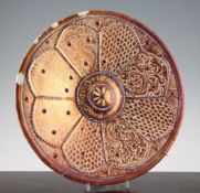 A Hispano Moresque style copper lustre dish, 19th century with a raised boss to the centre within