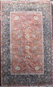 A Persian pattern carpet, with field of wild animals amongst scrolling foliage, on an orange ground,