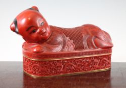 A Chinese cinnabar lacquer box and cover, modelled as a pillow, the cover with a recumbent figure of