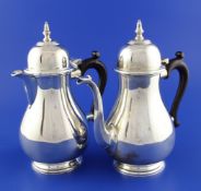 A 1970`s early 18th century design silver cafe au lait pair, of baluster form, with domed lids,