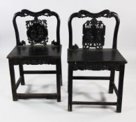 Two similar Chinese carved hardwood chairs, each carved and pierced splat back decorated with
