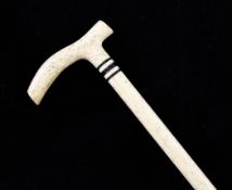 A 19th century whalebone walking cane, with shaped handle and baleen bands, 23.5in.