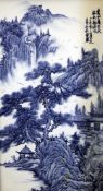 A Chinese blue and white rectangular plaque, painted with a sage in a mountainous river landscape