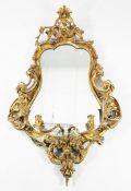 A 19th century gilt gesso cartouche shaped girandole, with mirror plate glass, four scrolling candle