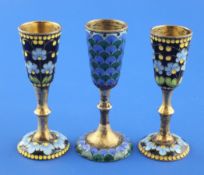 A pair of Soviet Union 91 zolotnik silver gilt and floral enamel pedestal tots and one other