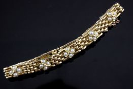 A 15ct gold and split pearl set gate link bracelet, with foliate motifs, gross 22.3 grams.