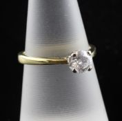 An 18ct gold and solitaire diamond ring, the claw set fancy round brilliant cut stone weighing 0.