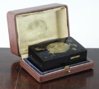 An early 20th century Swiss tortoishell singing bird box, with floral engraved gilt brass lid and `