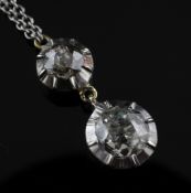 A Victorian style gold and two stone diamond set drop pendant necklace, with graduated collet set