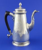 A George II silver coffee pot, of tapering form, with engraved armorial and acanthus leaf capped