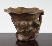 A Chinese bamboo libation cup, carved in high relief and open work with lotus, 10.5cm.