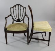 A set of six George III Hepplewhite style mahogany dining chairs, the shield backs with stiff leaf