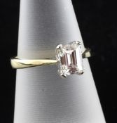 An 18ct gold and emerald cut solitaire diamond ring, the stone weighing 1.03ct, size M.