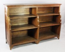 A late 19th century walnut parquetry inlaid double section open bookcase, the shaped sides with