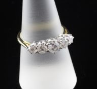 An 18ct gold graduated five stone diamond ring, the five round cut stones with an estimated total