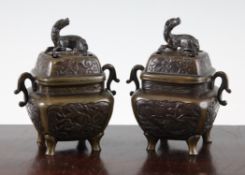 Two pairs of Japanese bronze koros and covers, c.1900, the first pair of cushion moulded square