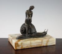 An early 20th century bronze figure group of a young maiden seated on a snail, on an onyx plinth