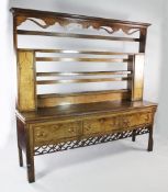 A George III oak and mahogany crossbanded North Country dresser, the open plate rack fitted with two