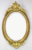 A large Victorian oval gilt wall mirror, with pierced acanthus scroll crest and bevelled mirror