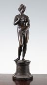 After The Antique. A late 19th century patinated bronze figure of the Venus Medici, on a circular