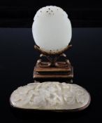 A Chinese white jade plaque and a grey jade oval plaque, 18th / 19th century, the 18th century white