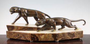 J. Hugues. A bronze panther group, mounted on a stepped onyx base, both models signed inner rear