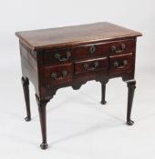 A mid 18th century mahogany lowboy, fitted an arrangement of four drawers with rocaille brass