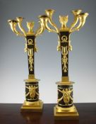 A pair of 19th century bronze and ormolu Empire style candelabra, the square tapering columns