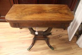 A 19th century mahogany folding card table, with baize interior on U shaped leaf carved support,