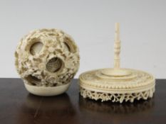A large Chinese ivory concentric puzzle ball and stand, early 20th century, the ball carved in