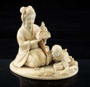 A Japanese ivory okimono of a bijin and a small boy, Meiji period, the kneeling lady holding a