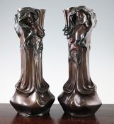 A pair of patinated bronze Art Nouveau style vases, with female mask and floral decoration, 17in.